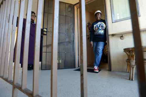 Hacienda residents Clara Moore, left, and Geneva Eaton chat in the hallway at the public housing apartment complex in Richmond, Calif. on Wednesday, Feb.